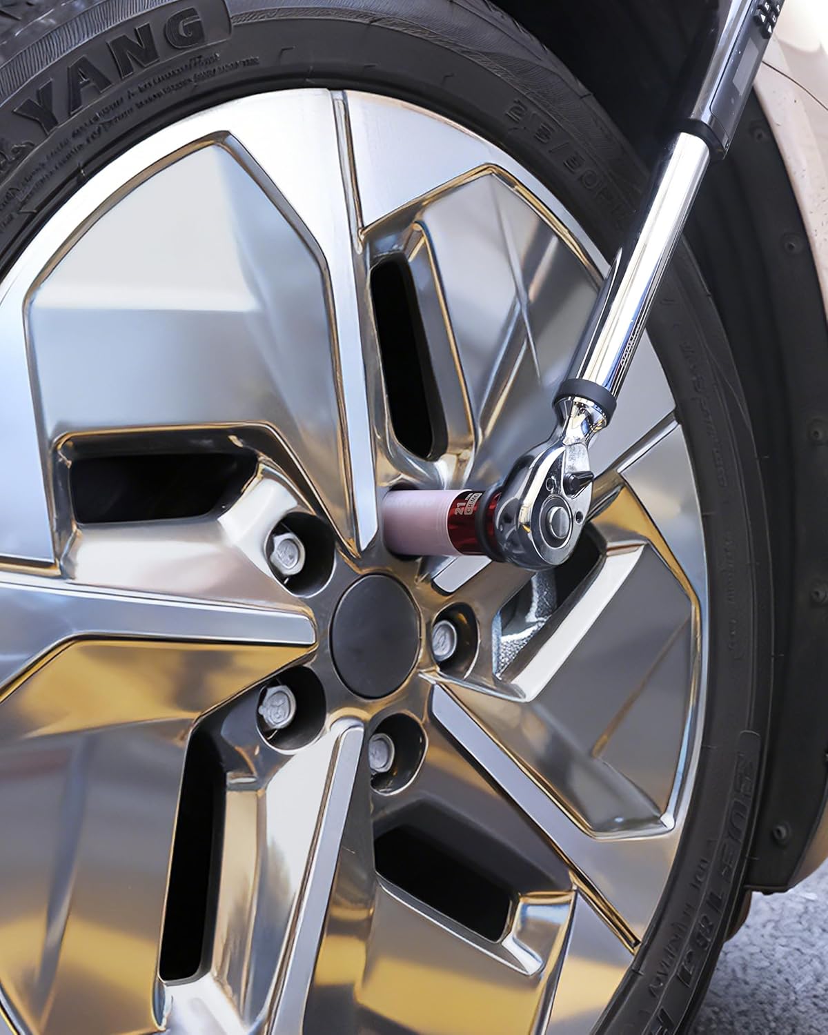 Impact socket fitted on a wheel lug nut, showing the red 21 mm socket end