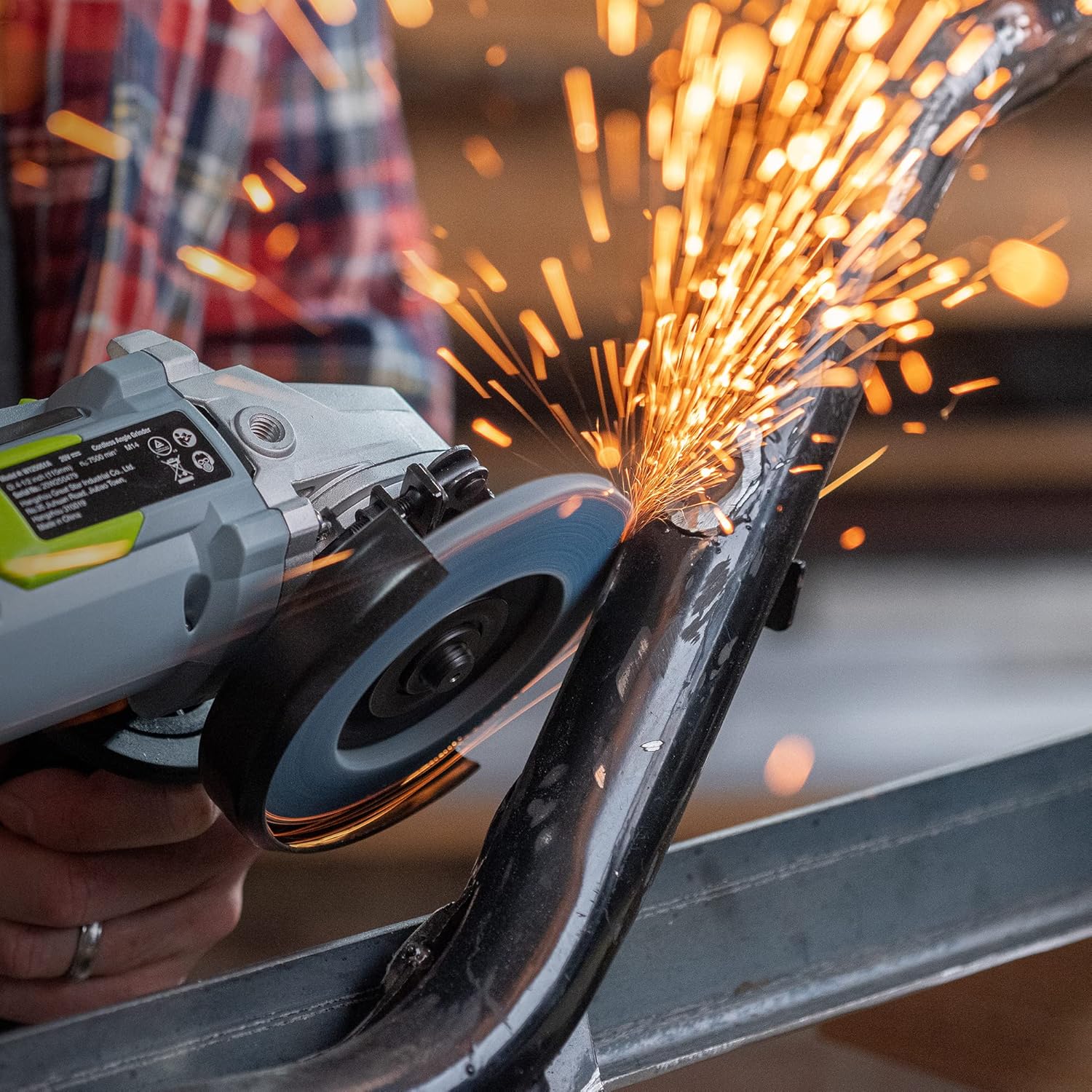 Angle grinder using a blue zirconia flap disc, grinding metal with sparks