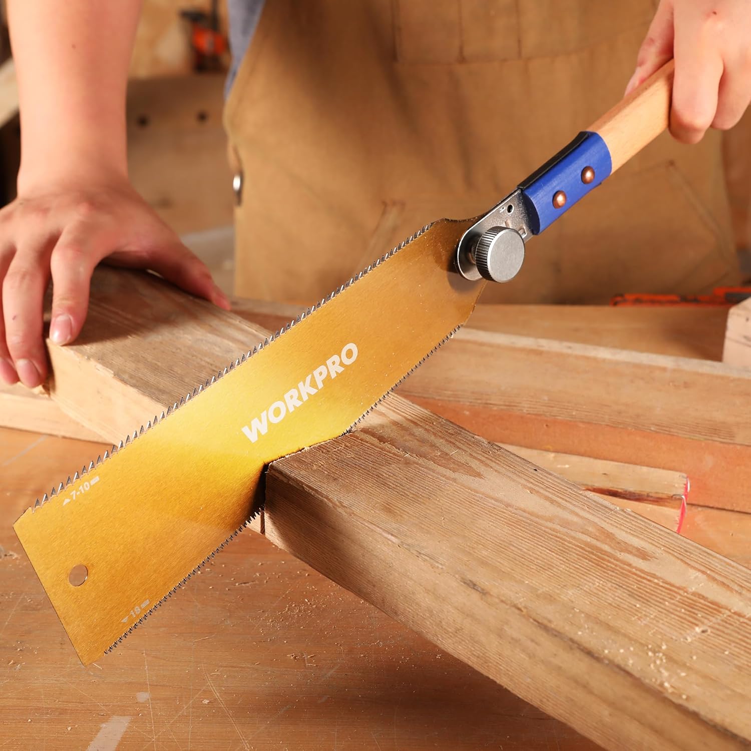 Japanese pull saw cutting a wooden board; beech handle and toothed blade