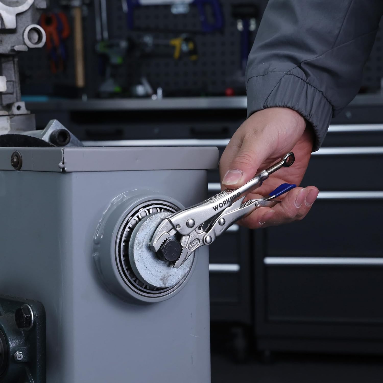 WORKPRO locking pliers gripping a wheel rim on workshop equipment