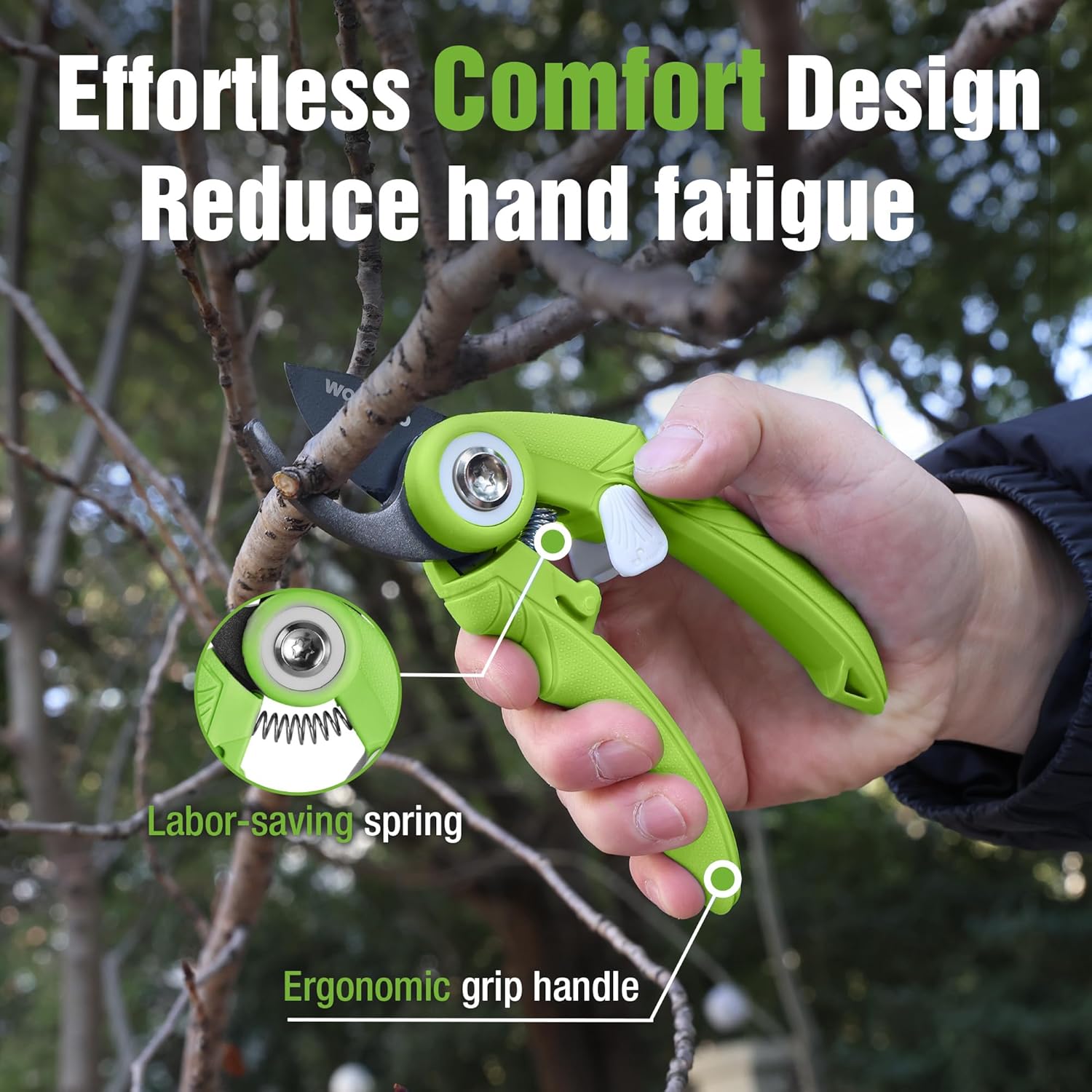 Green bypass pruning shears with ergonomic handles held while pruning branches