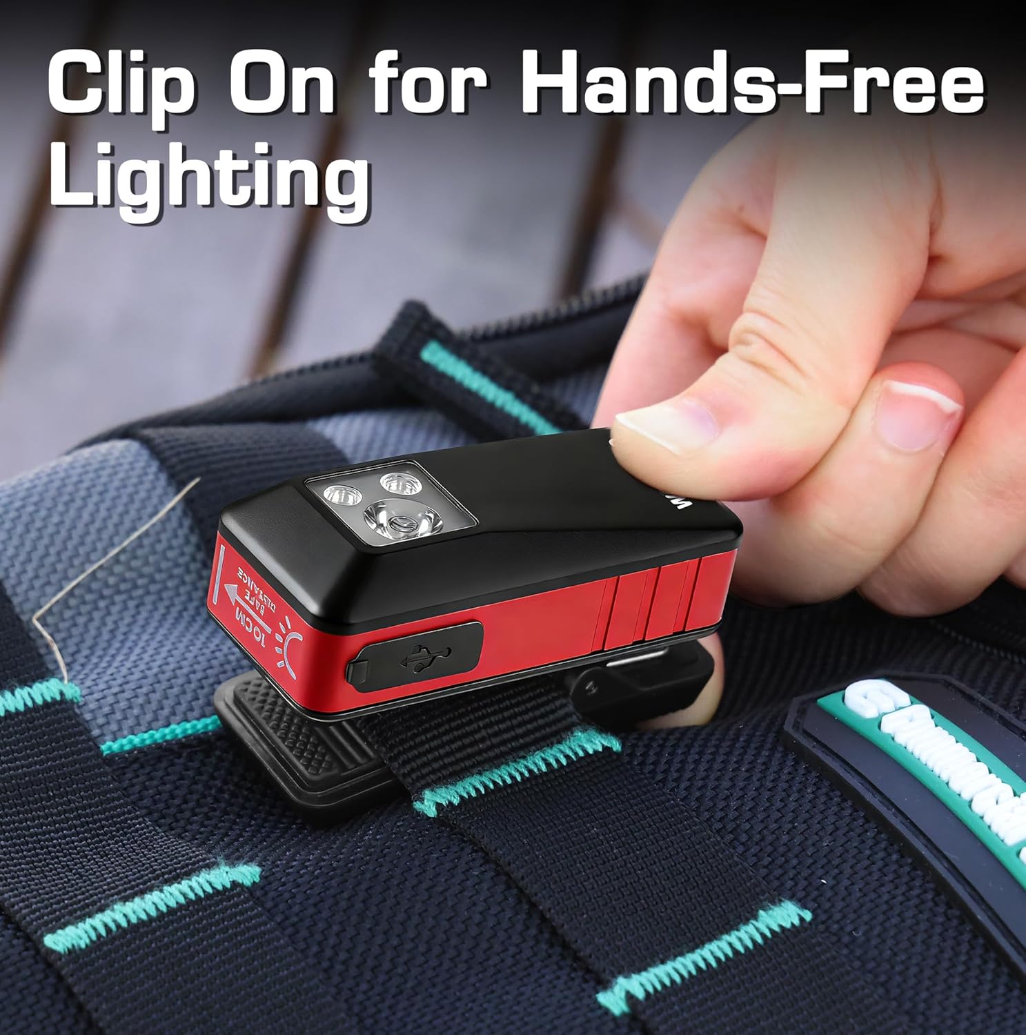 Clip-on rechargeable pocket flashlight, red and black, held in a hand