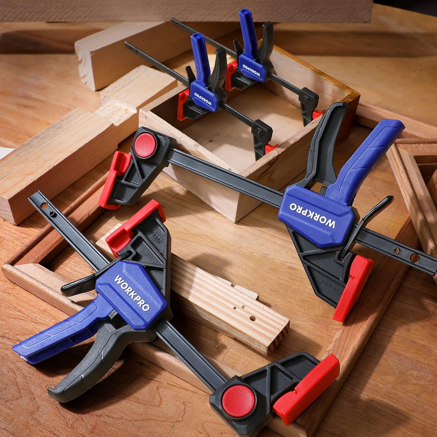 Set of WORKPRO mini bar clamps and spreaders on wooden workpieces