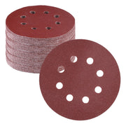5-inch sanding discs with 8-hole pattern, maroon hook-and-loop abrasive backing, stacked.