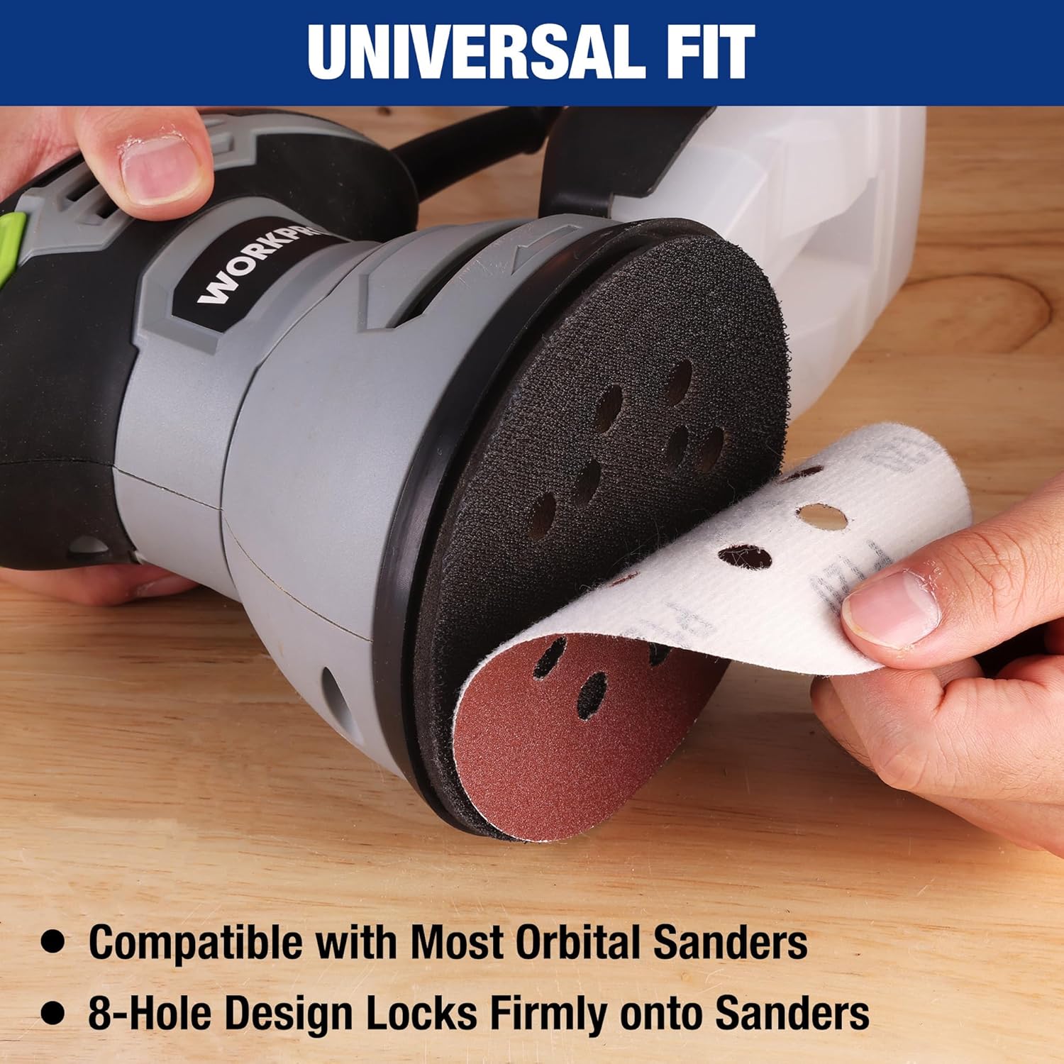 Sanding disc attached to orbital sander, dark red-brown with 8-hole pattern