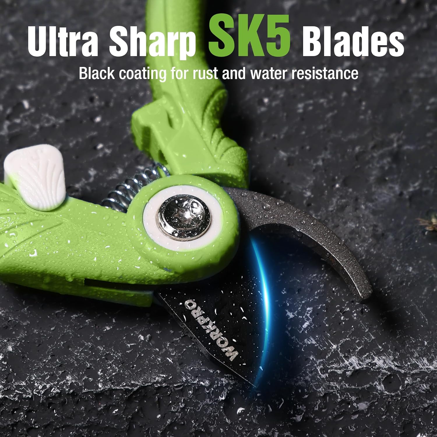 Close-up of green pruning shear blade and pivot mechanism on dark surface