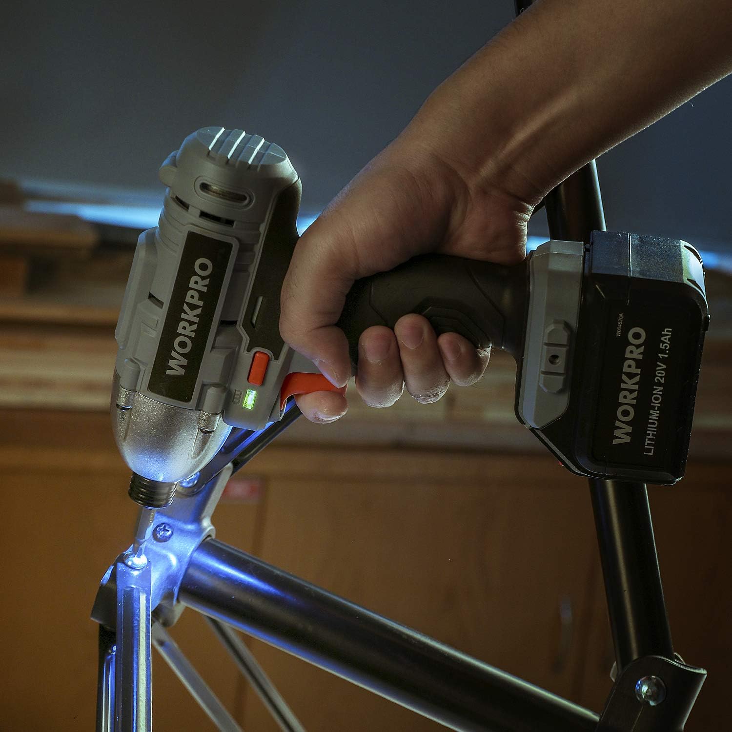 WORKPRO cordless drill held with lithium battery pack attached