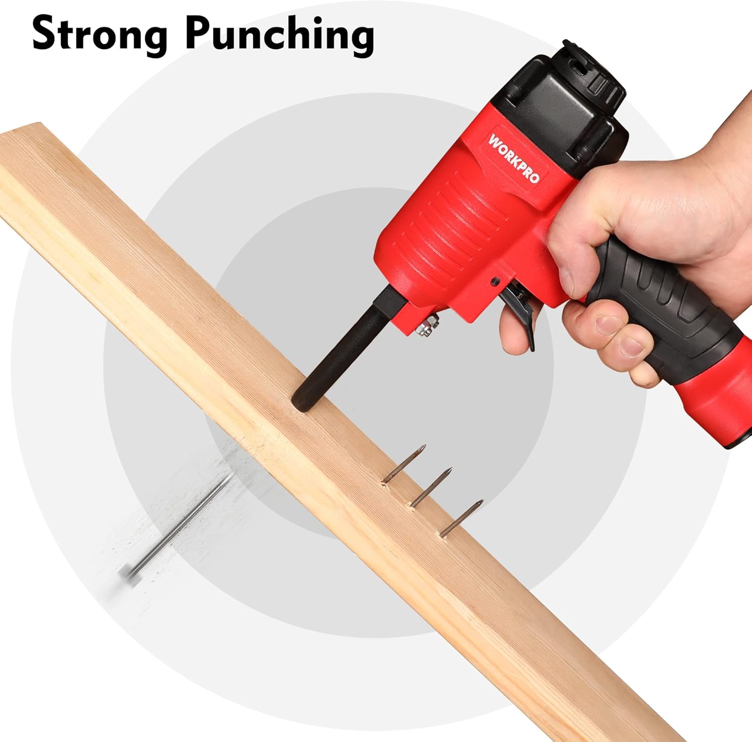 Pneumatic nail remover gripping wood board, pulling/removing nails with red-and-black tool