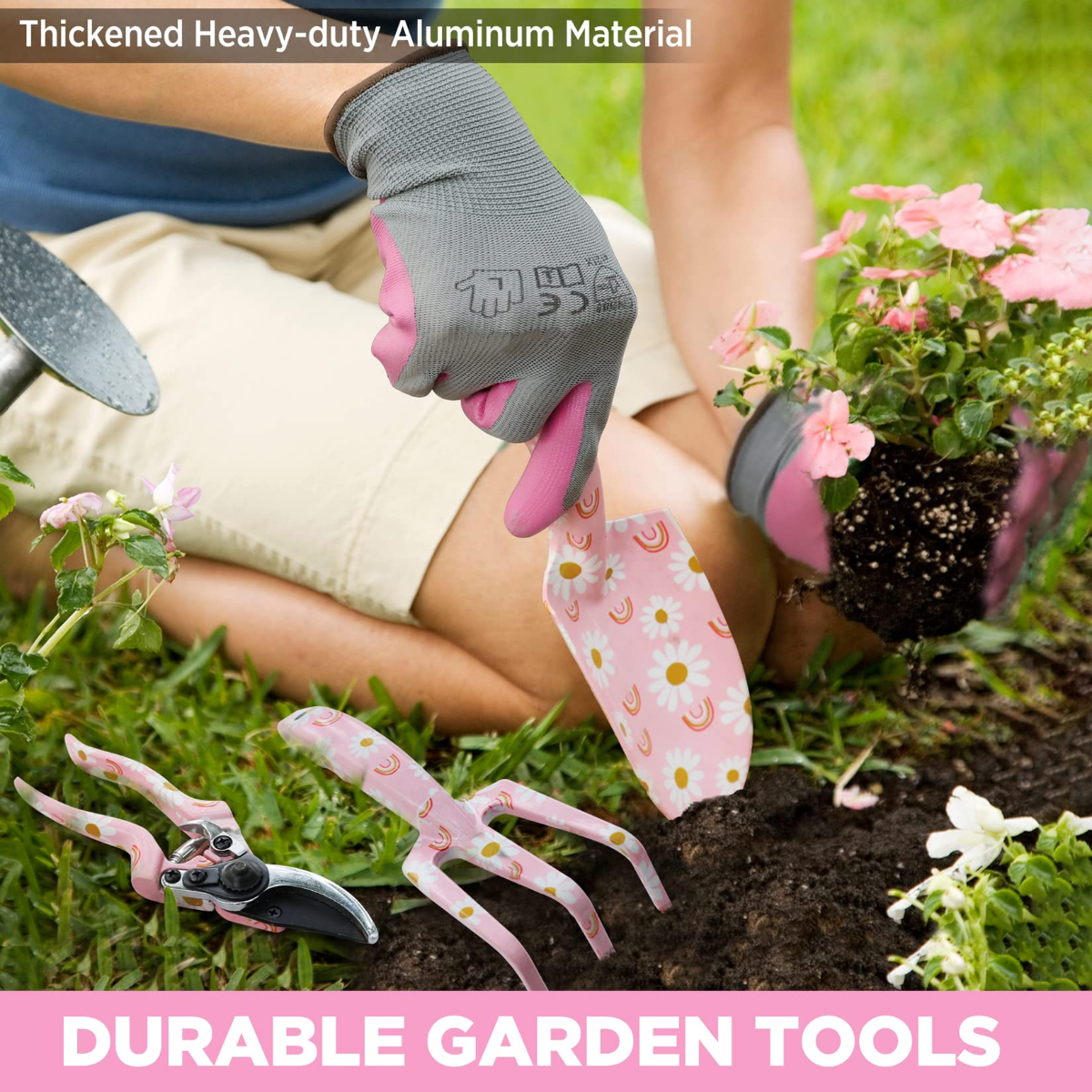 Grey gardening gloves holding a potted plant, with pink floral tool grips nearby