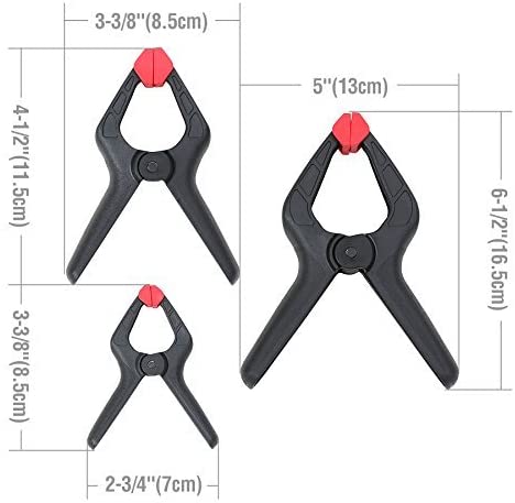 Black spring clamp with red jaw pads, 3-3/8 in overall length shown