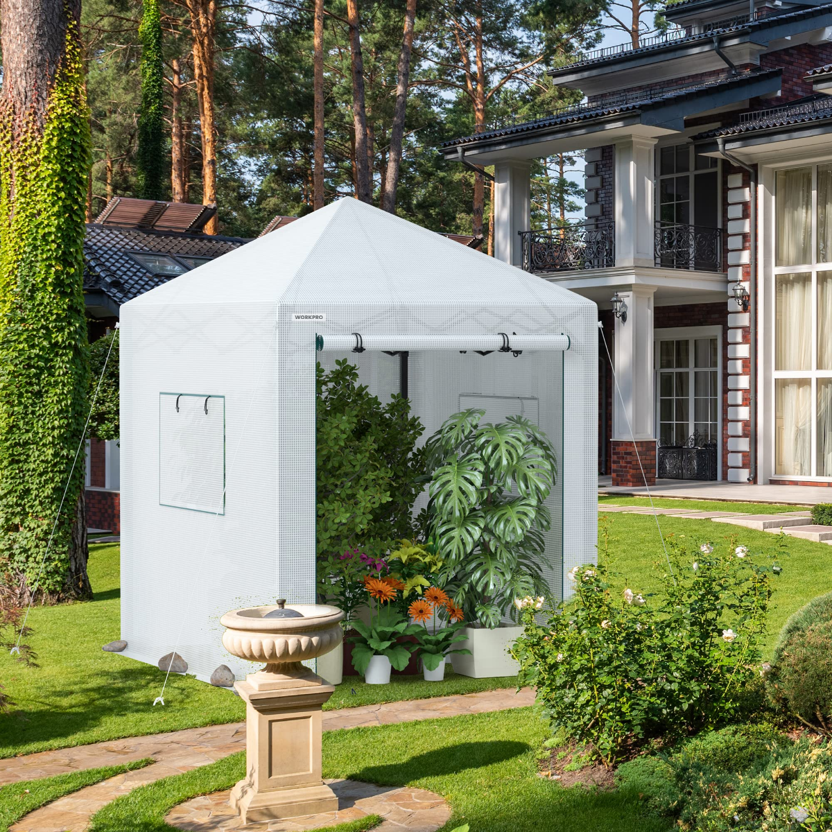 Portable walk-in greenhouse with clear mesh walls, roll-up door, and potted plants