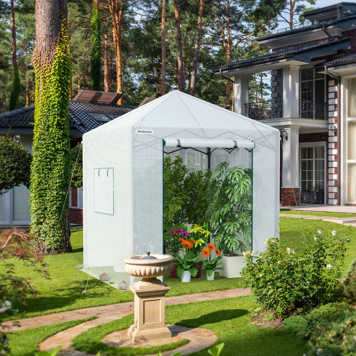 White portable walk-in greenhouse with mesh walls, front doorway, and plants inside in yard
