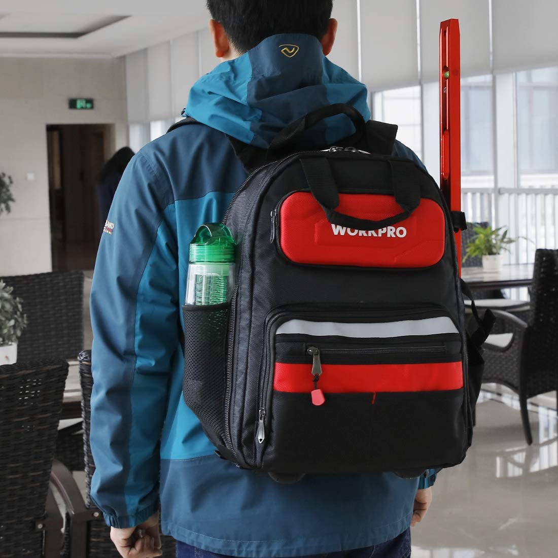 WORKPRO tool backpack worn on back with front red zip pocket and organizer stripe