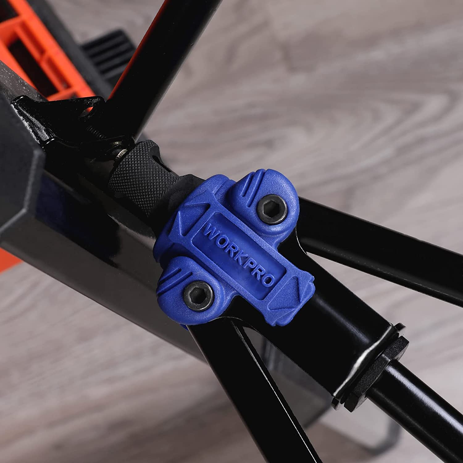 Close-up of WORKPRO blue rivet nut setter on black tool arms, showing mandrel head