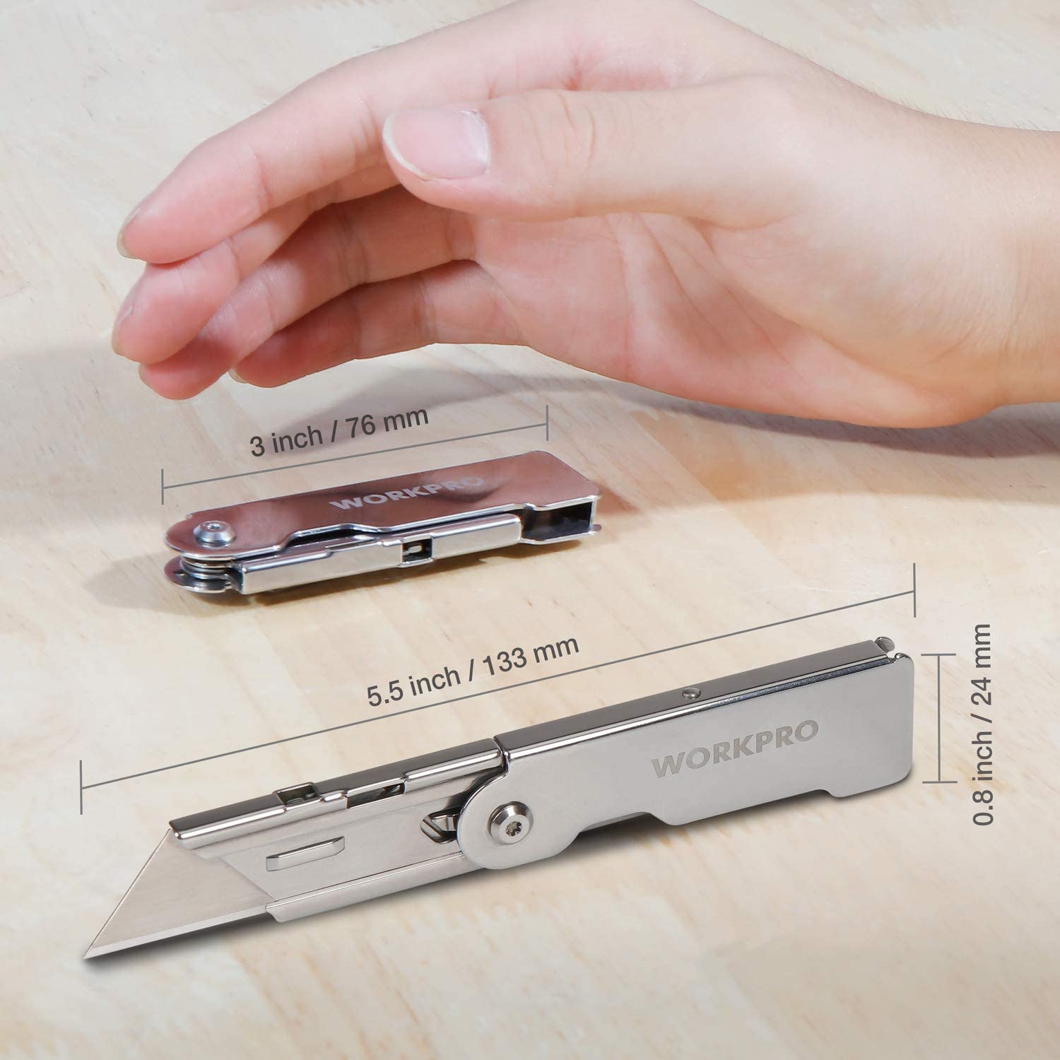 Compact folding utility knives with quick-release mechanism, shown with palm size