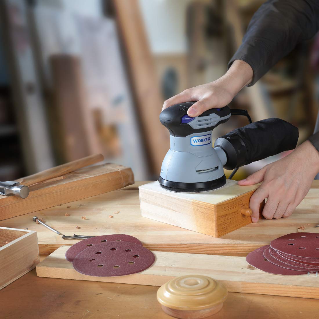 Red sanding discs set for random orbital sander, shown in use