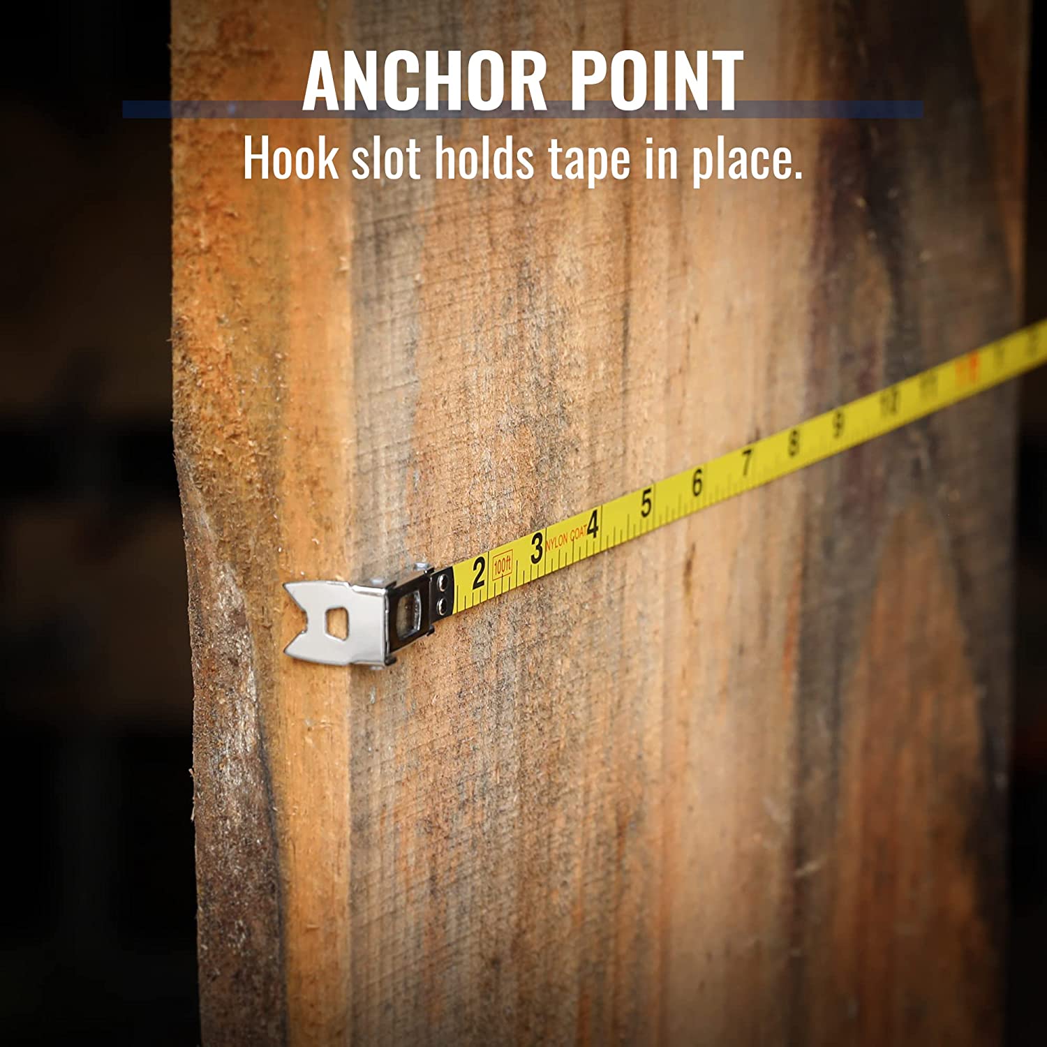 Steel tape measure anchor point on wood with metal hook and yellow tape markings