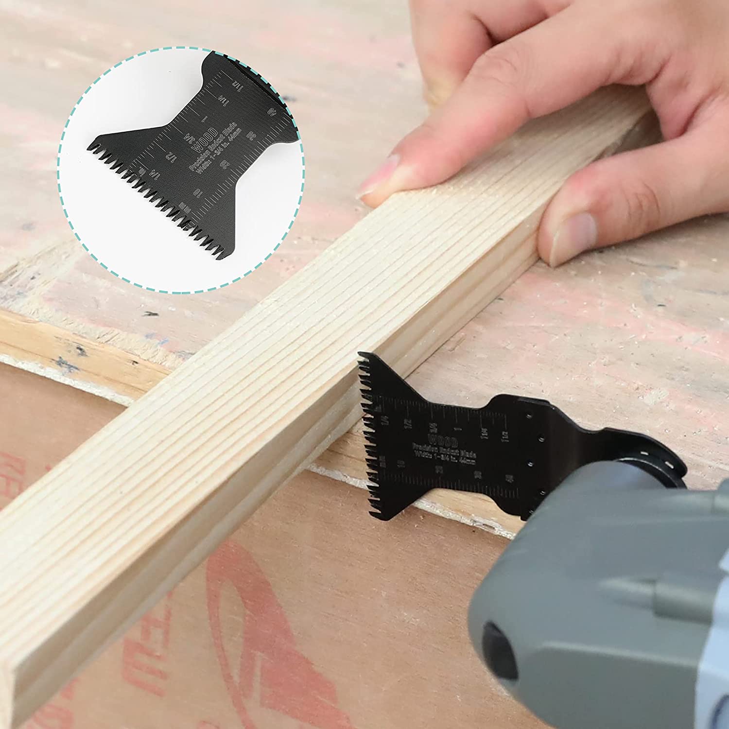 Oscillating saw blade cutting a wooden board, black bi-metal tooth edge
