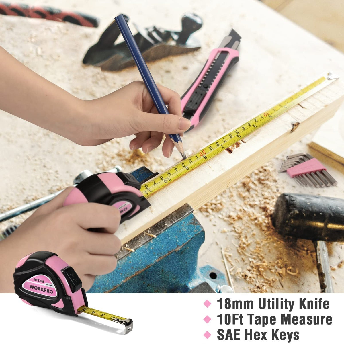 Utility knife with pink-and-black handle, measuring tape and hex key set on wood
