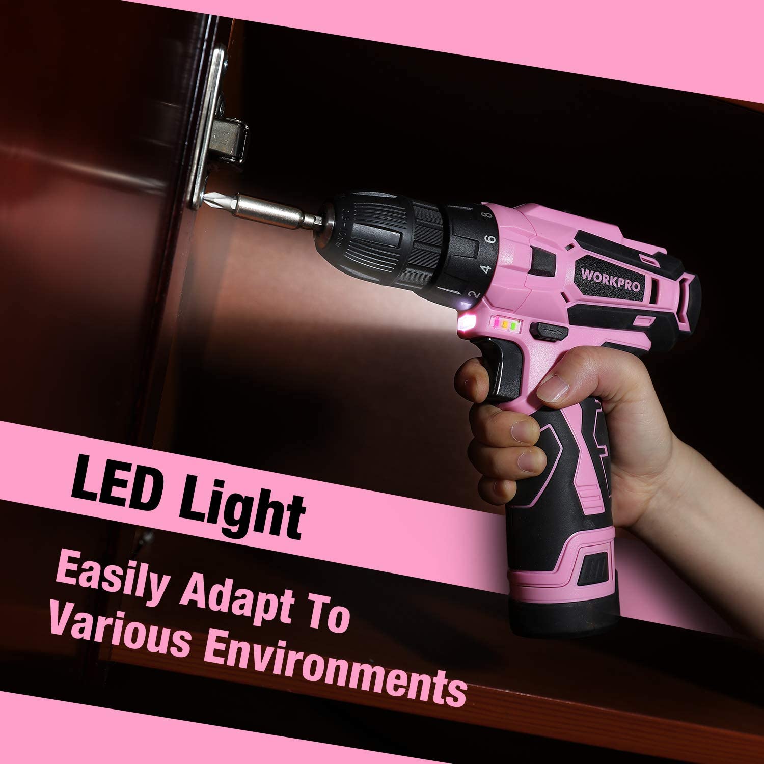 Pink cordless drill with LED light, held in a hand for drilling on wood