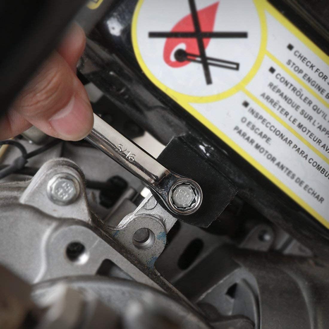 Close-up of socket and fastener on a metal engine component with wrench tool