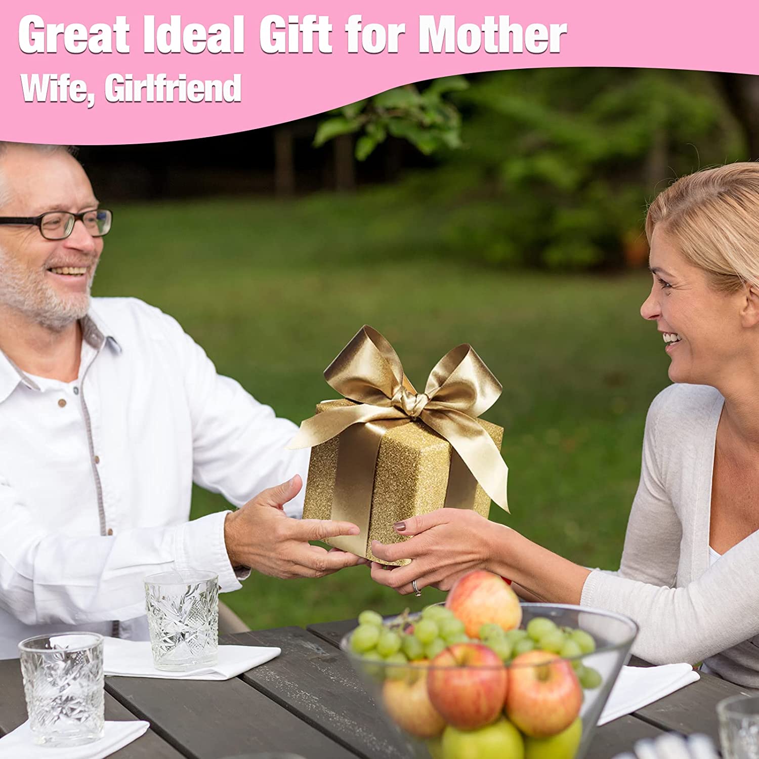 Couple outdoors holding a gold gift box with ribbon, promotional scene