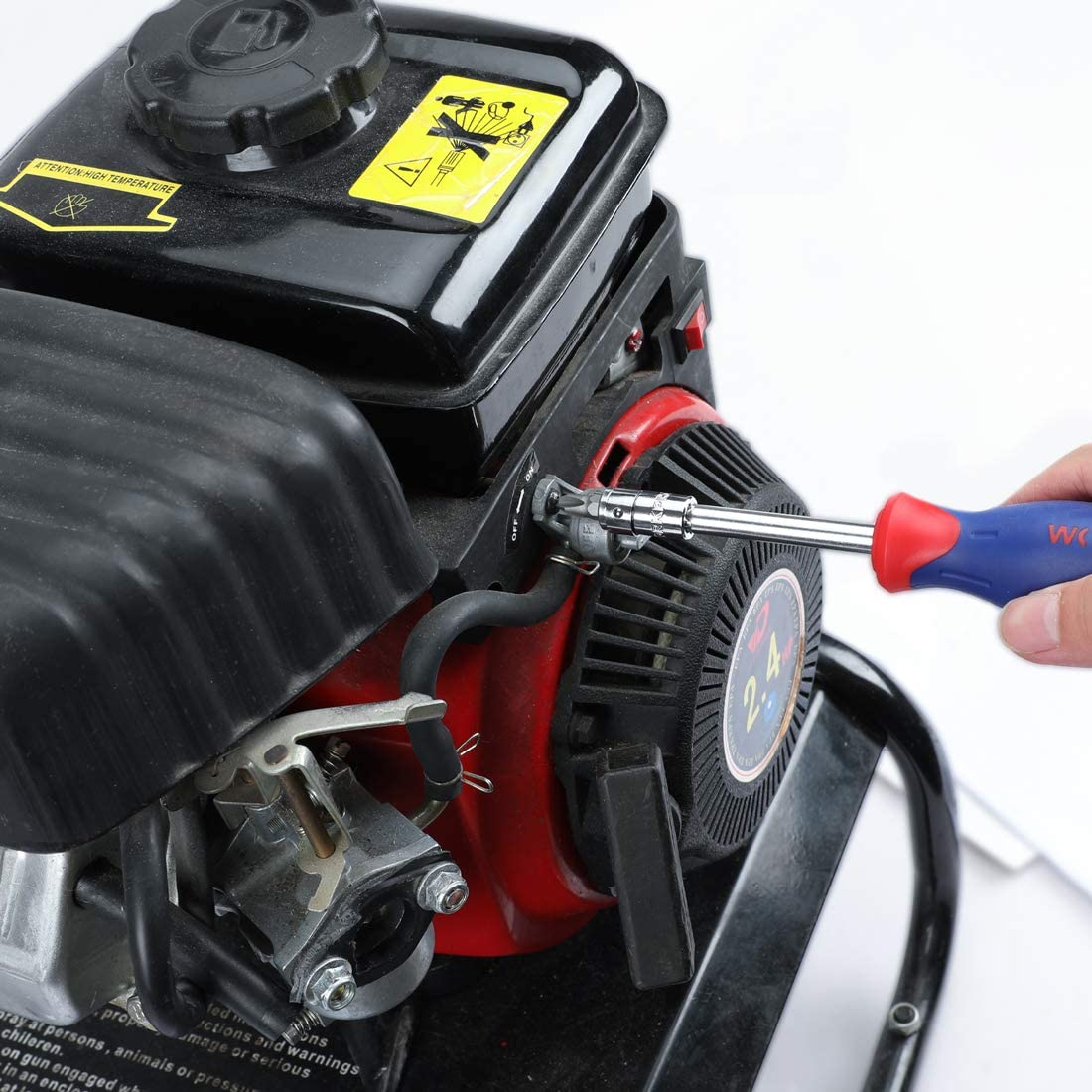 1/4-inch ratchet and socket working on a small engine component