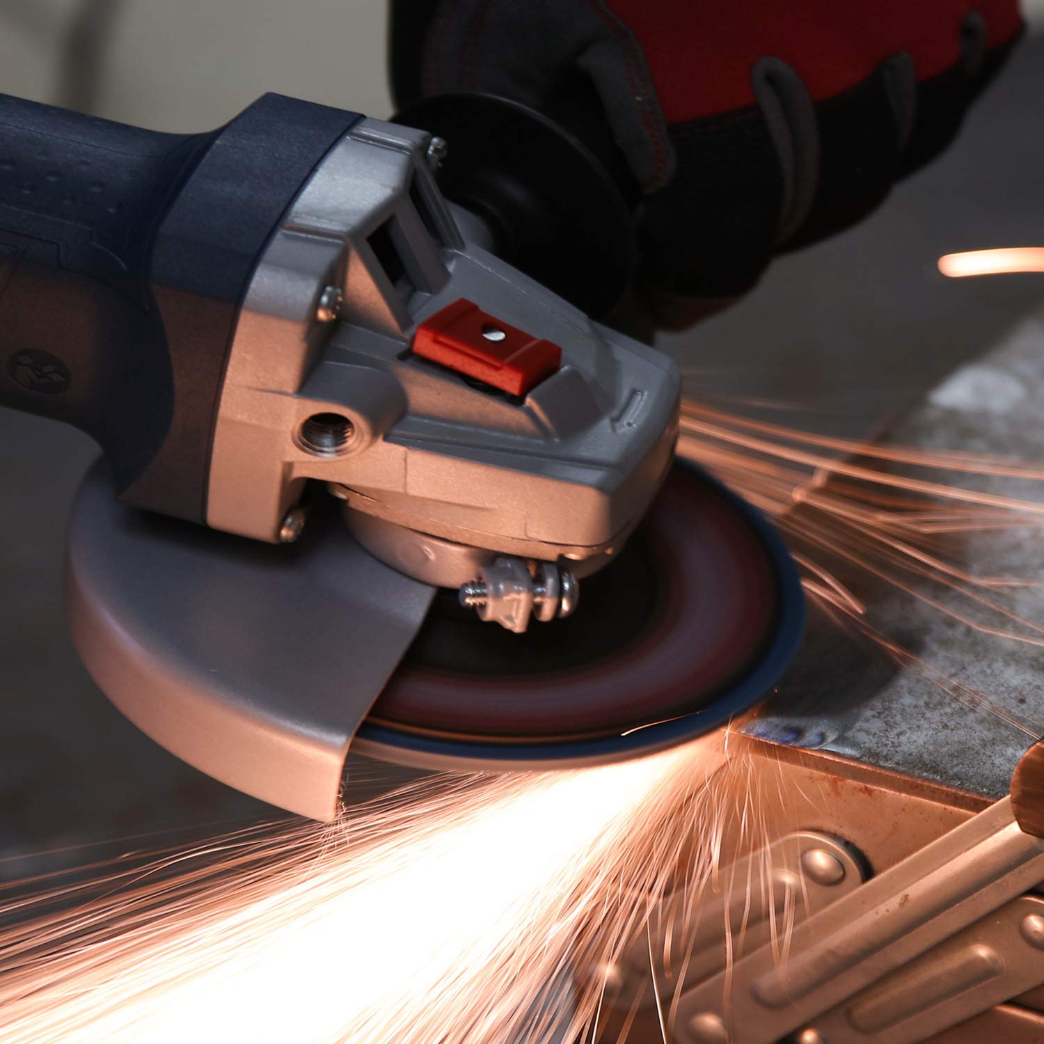 Blue zirconia flap grinding disc on an angle grinder, sparking during use