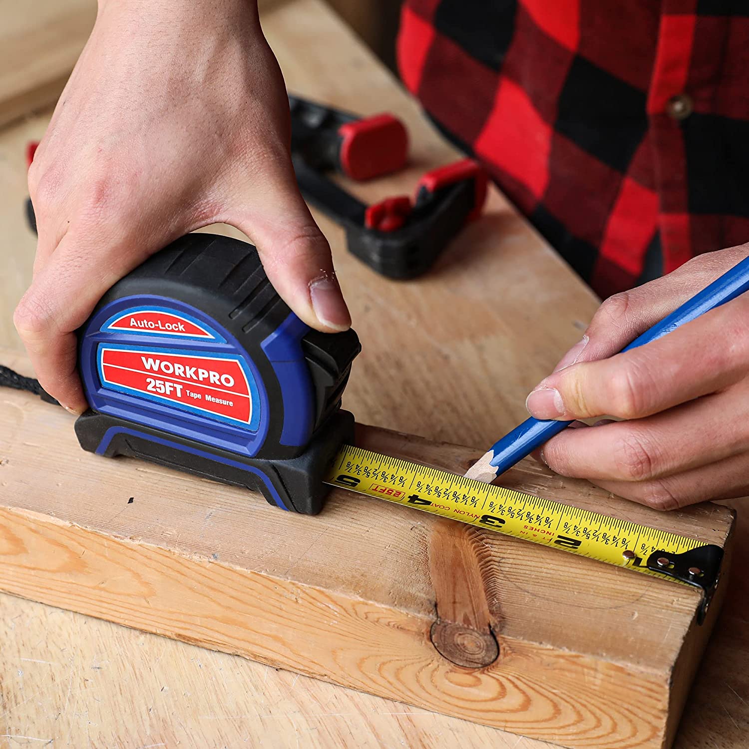 Auto-lock tape measure measuring a wooden plank with yellow tape extended