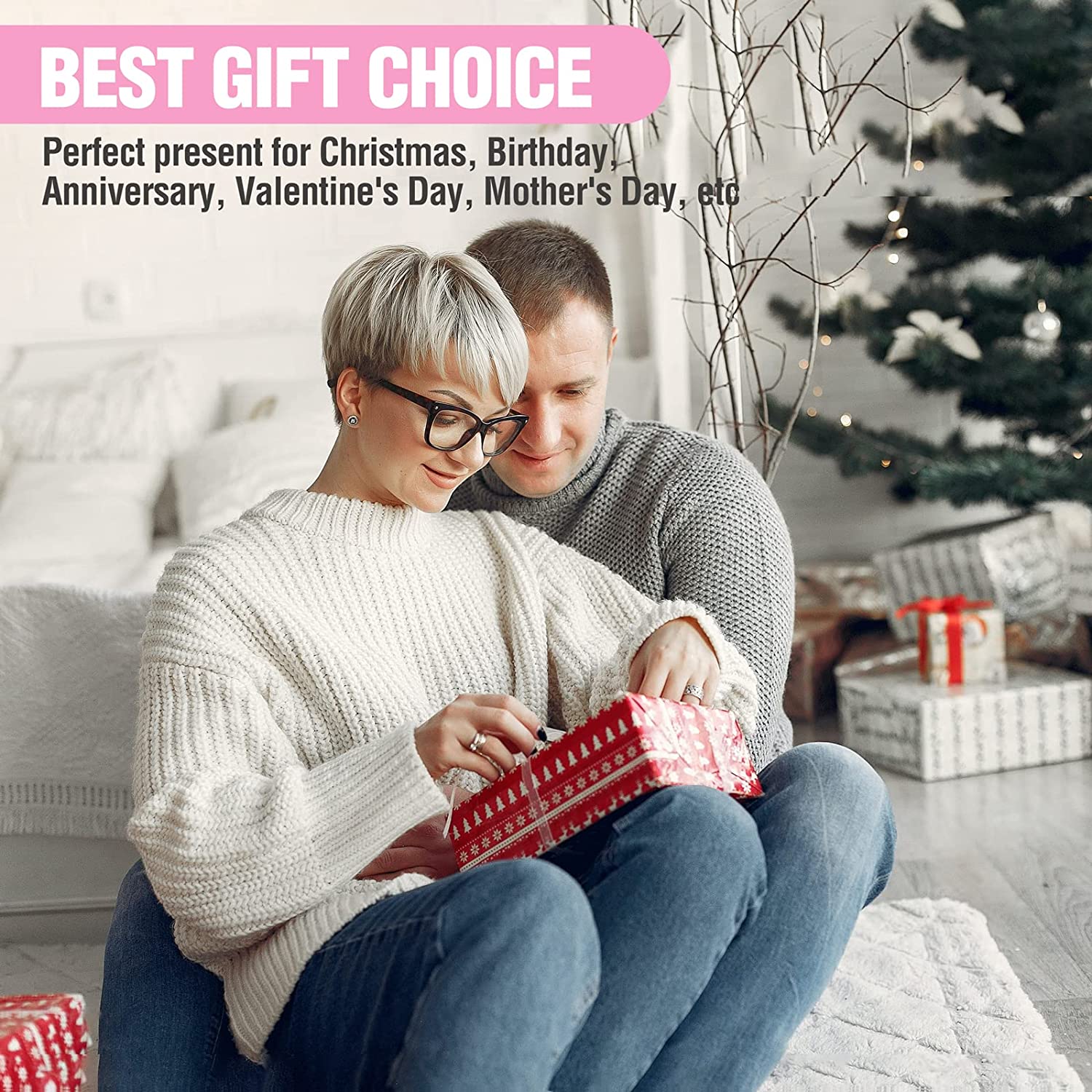People cuddling while wrapping a red gift on a sofa