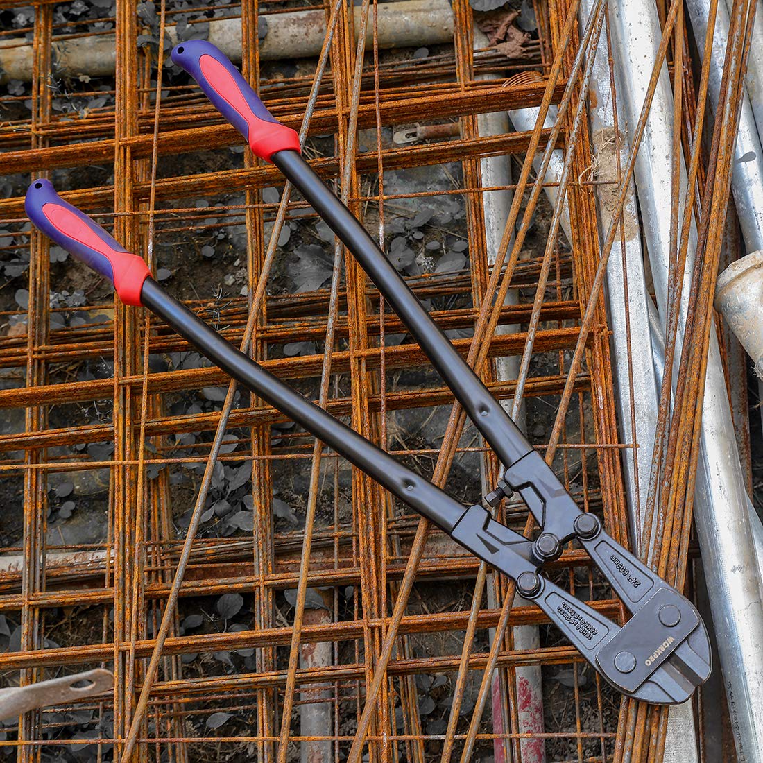 Bolt cutter with red handle sleeves and long black arms on rebar
