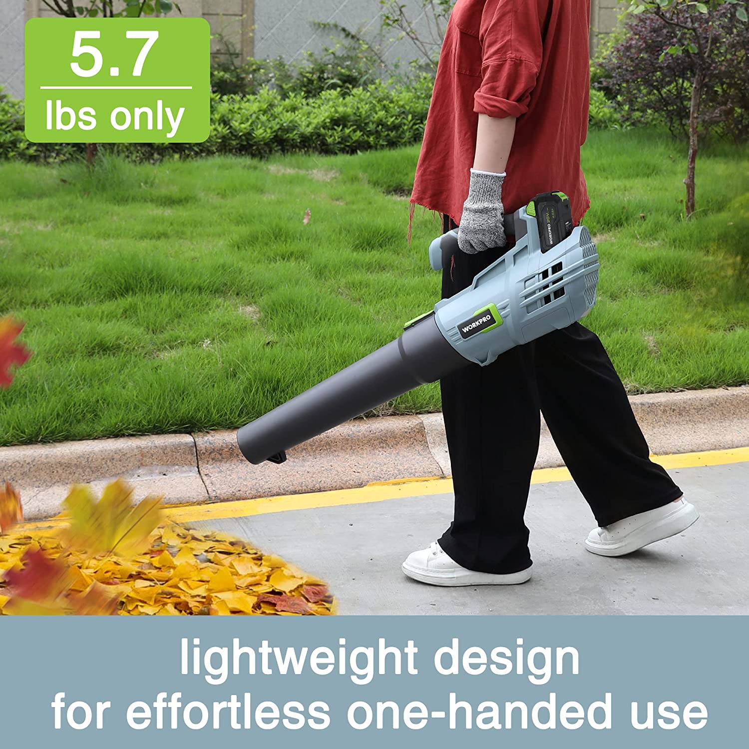 Cordless leaf blower with long black nozzle, used outdoors on driveway and lawn