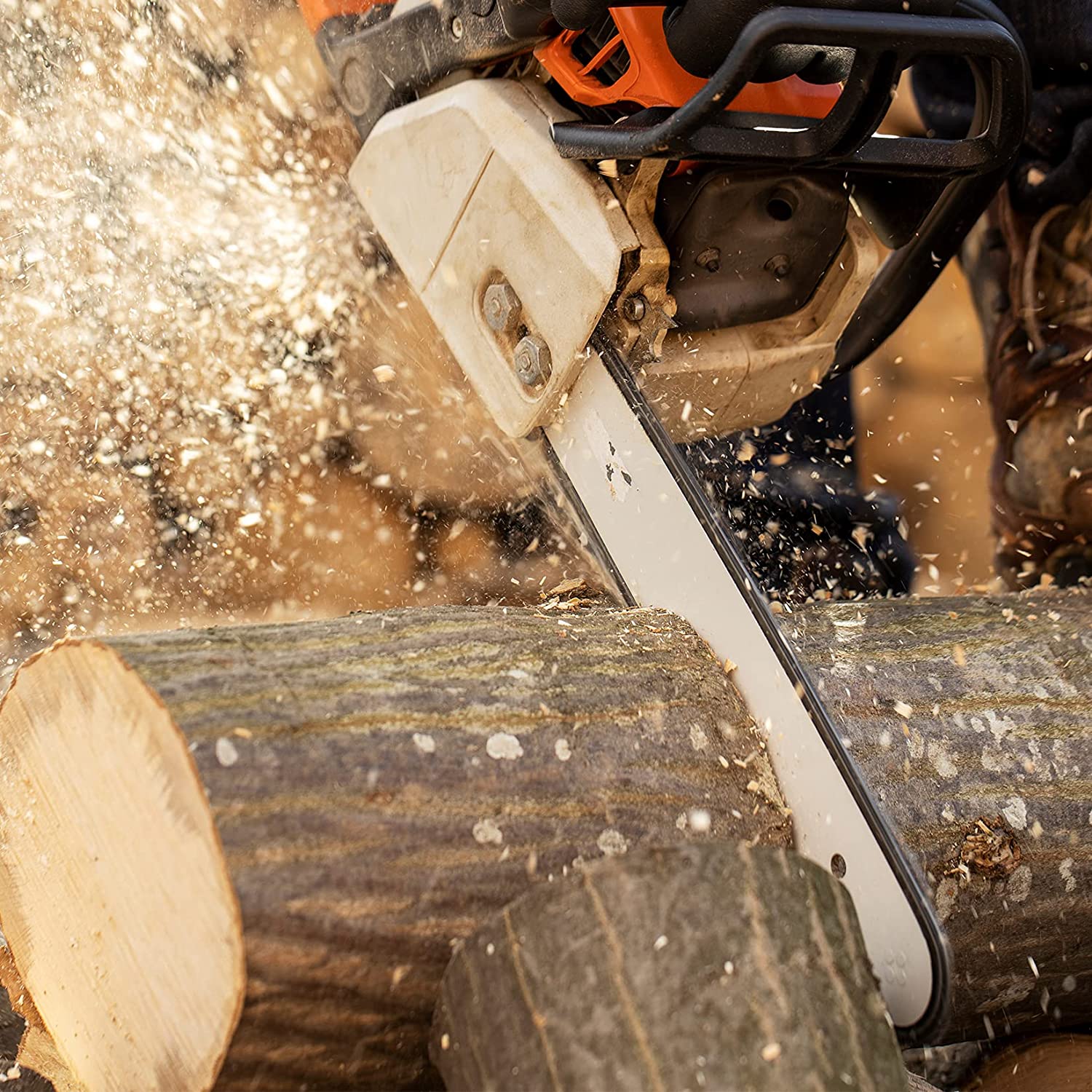 Chainsaw guide bar with chain actively cutting wood, with sawdust and sparks