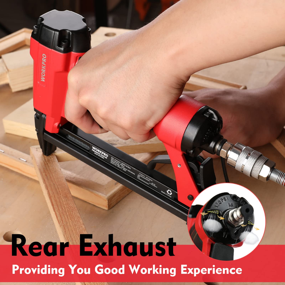 Pneumatic staple gun held to a wooden board with the nozzle and rear exhaust
