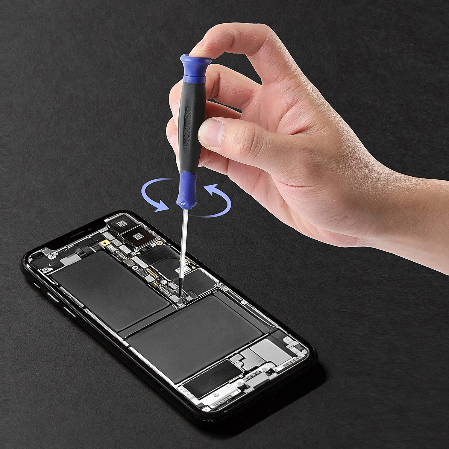 Precision screwdriver being used by hand on a smartphone repair tool kit