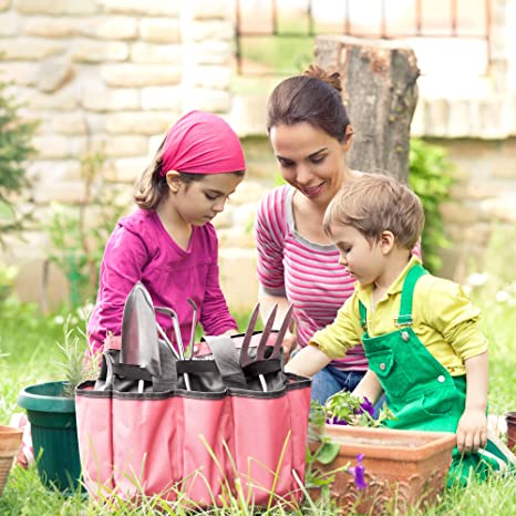 Pink garden tool tote bag with tools in pockets during outdoor gardening