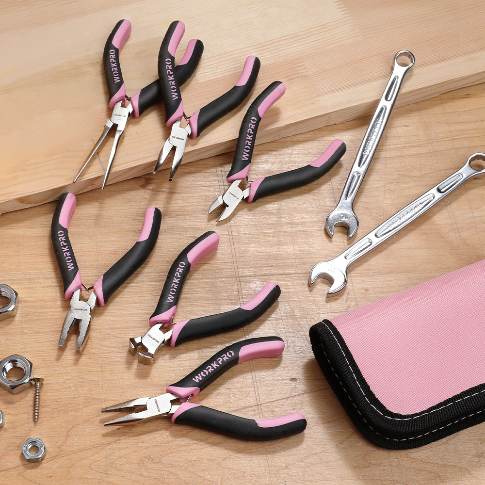 Assorted mini pliers with pink-and-black handles and a pink zip pouch on a workbench