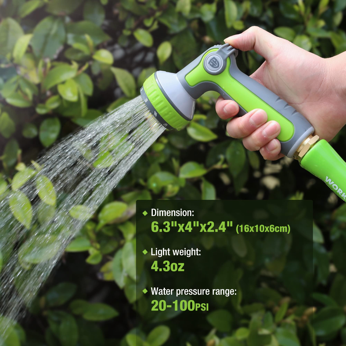 Green and gray garden hose nozzle sprayer held in hand, spraying a steady stream