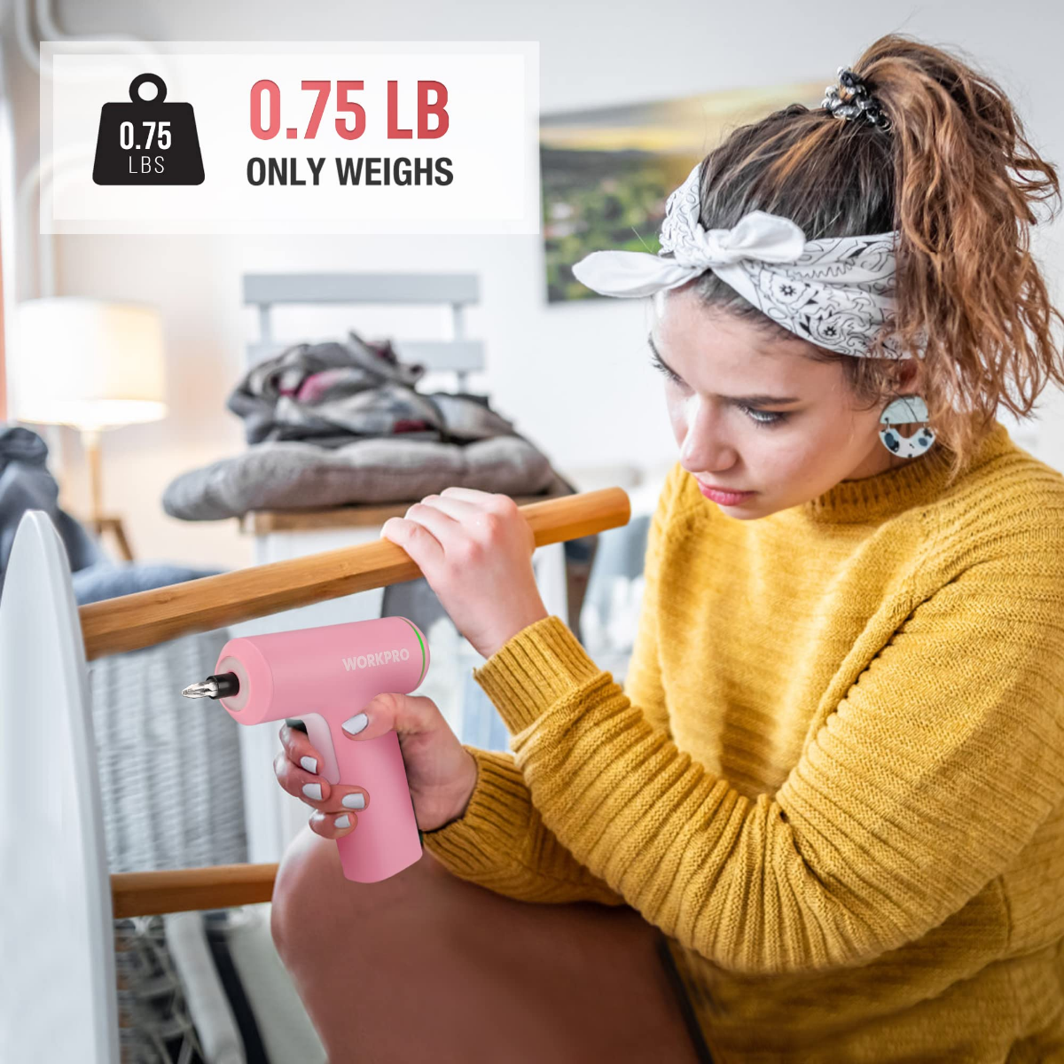 Pink cordless electric screwdriver with bit tip, shown held in hand for use