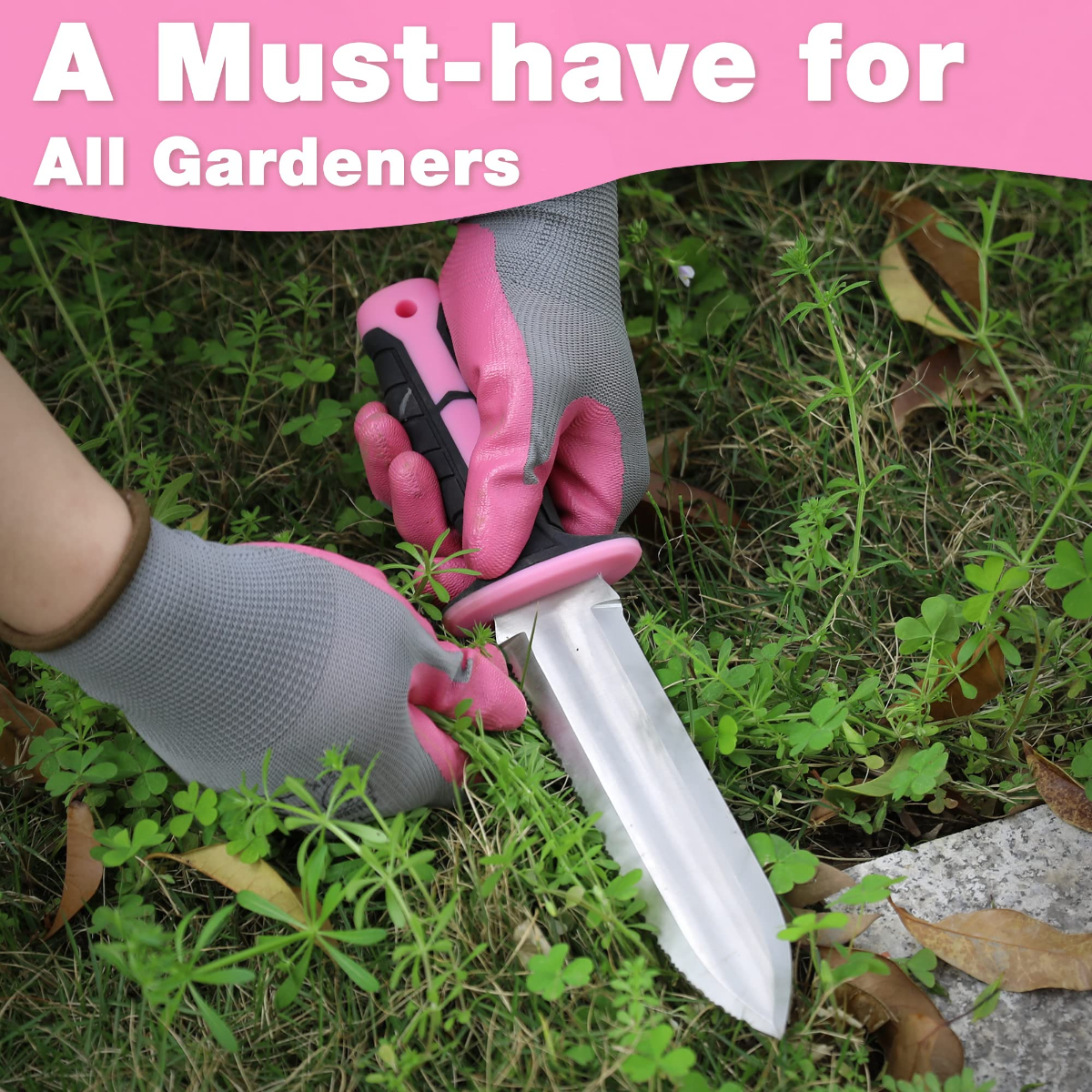 Handheld garden knife with pink handle cutting into grass beside stone path